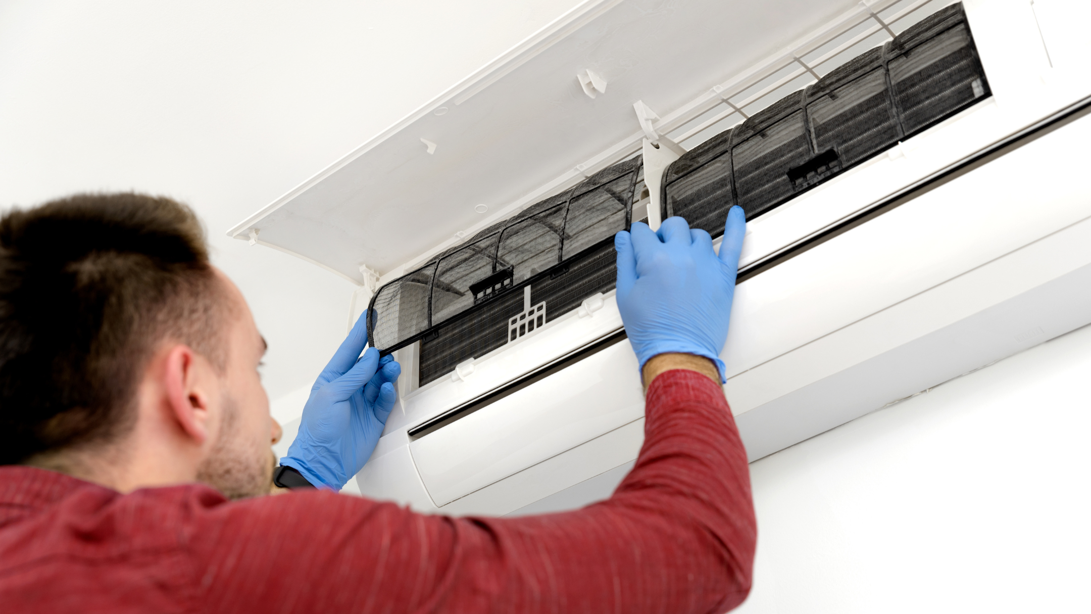 professional i blue gloves performing indoor air quality service